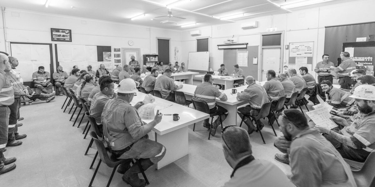 Miners during a safety briefing going over processes and protocols.